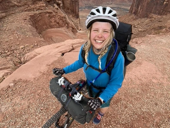 Franny Slater riding a bike in the desert