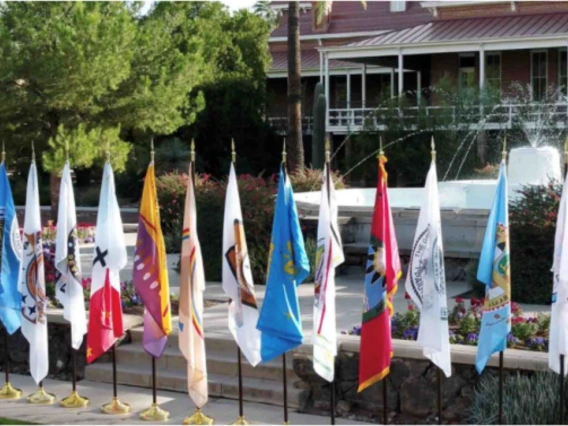 Flags from Tribal Nations being displayed in front of Old Main on the UA campus