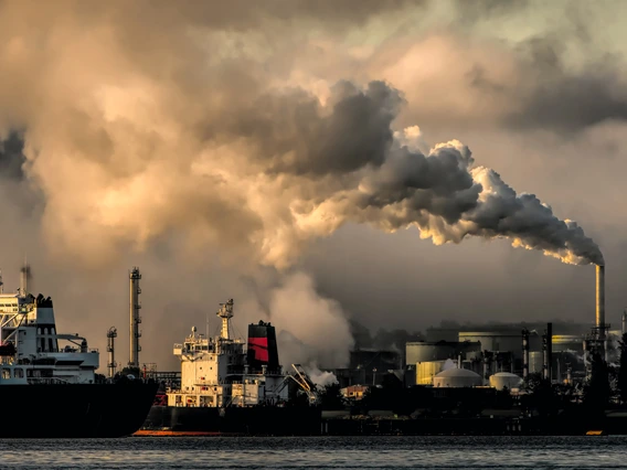 An image of an offshore oil rig with heavy smoke.