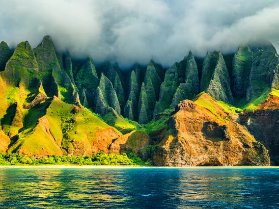 Na Pali coast, Kauai, Hawaii view from sea sunset cruise tour. Nature coastline landscape in Kauai island, Hawaii, USA.
