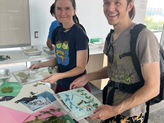 Two students hold cyanotype prints