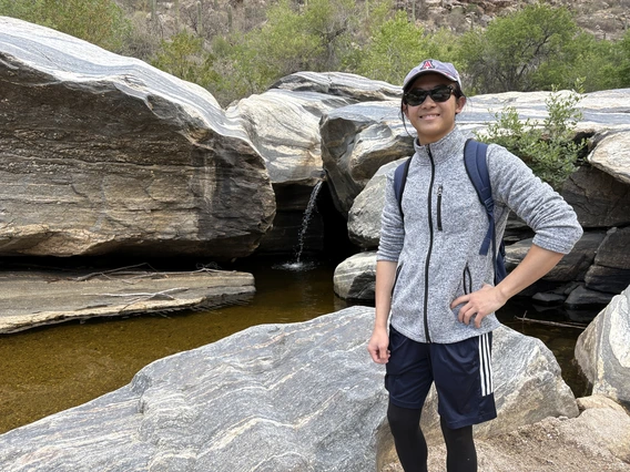 Minh Ngo in front of a waterfall