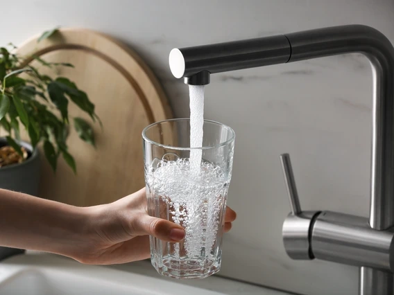 water running from a tap into a glass