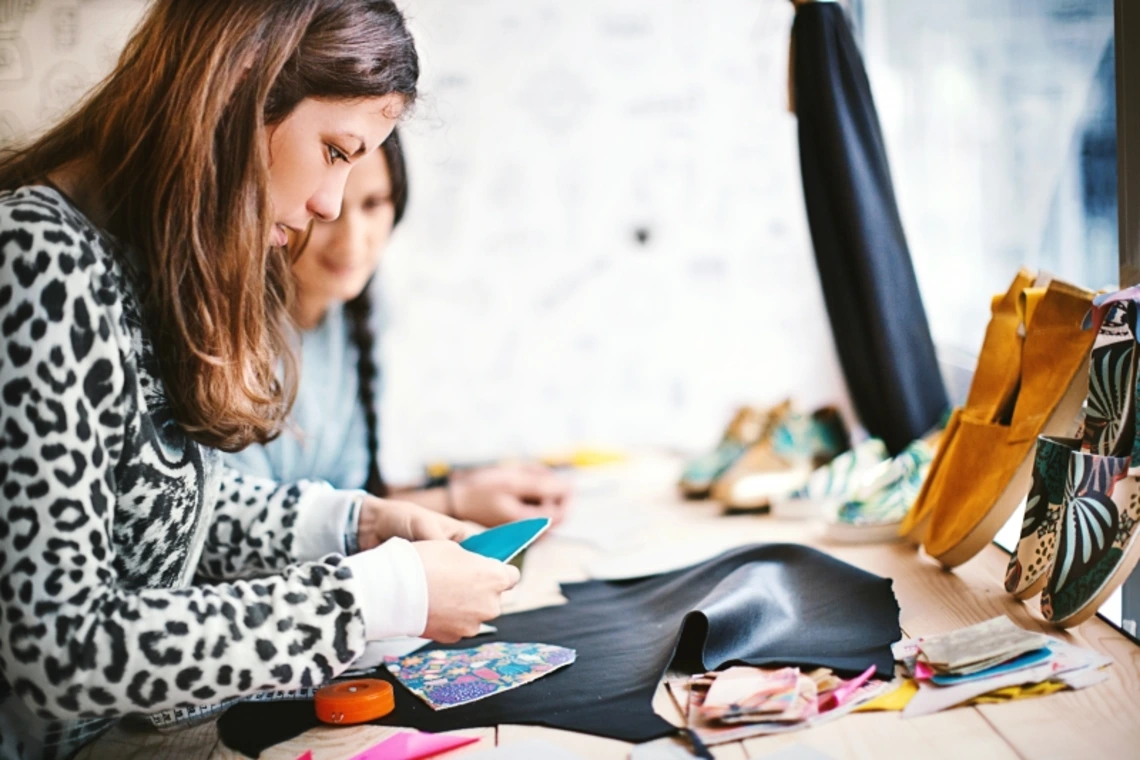 Two students working on a clothing design together