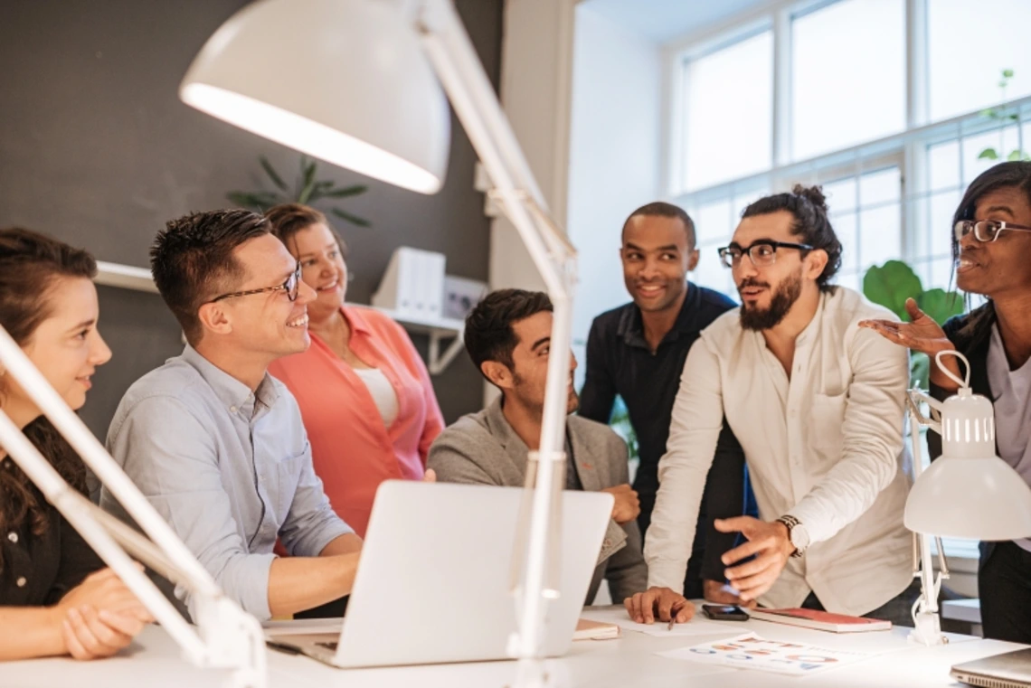 A group of people discussing a design together
