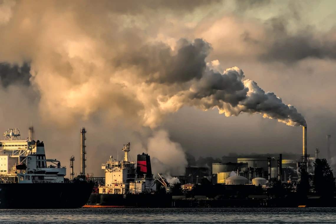 An image of an offshore oil rig with heavy smoke.