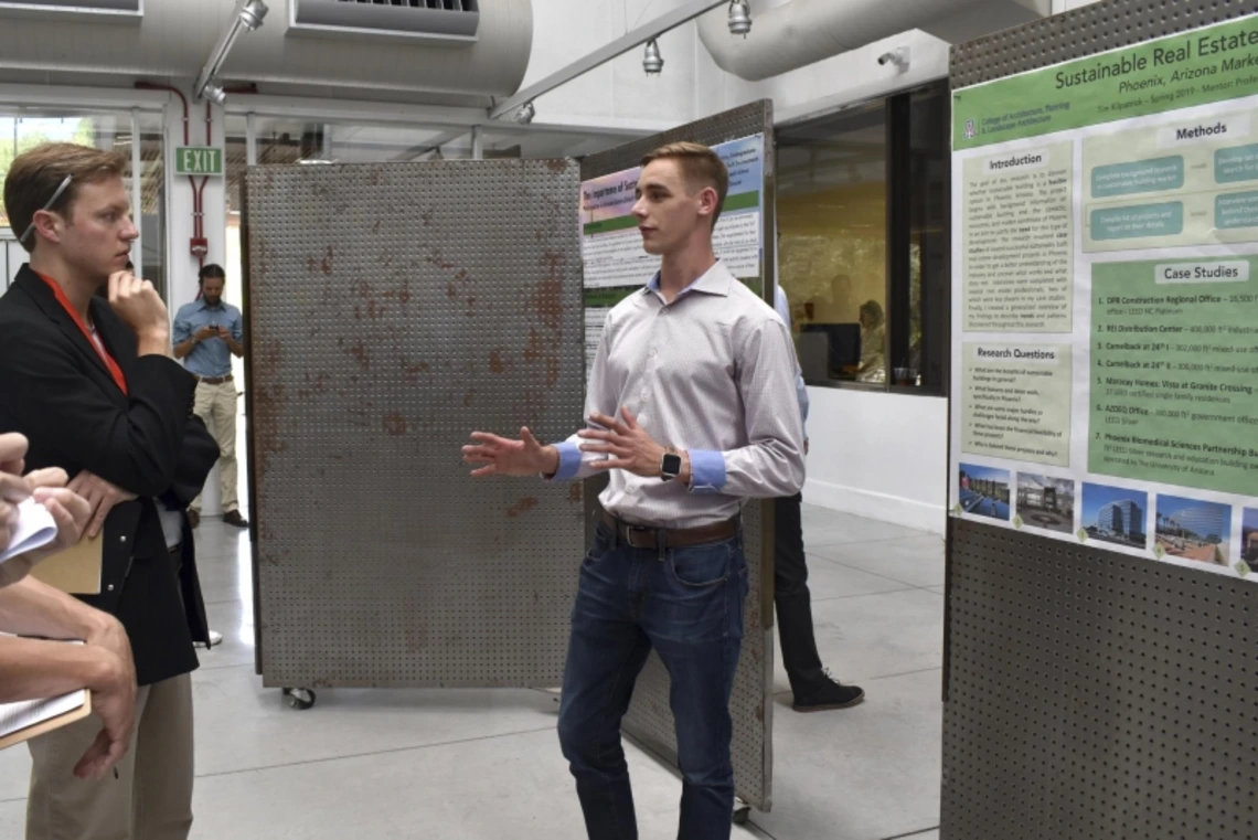 A man giving a poster presentation