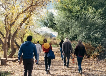 Educators walking among trees