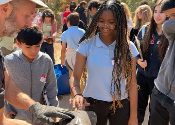 Students look at river sample
