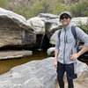 Minh Ngo in front of a waterfall