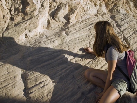 A student examining rocks