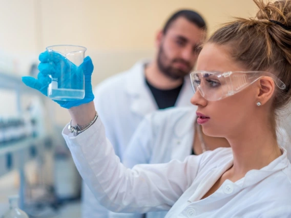 A researcher examining chemicals in a lab