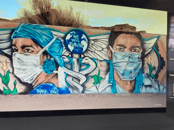Graffiti art of a doctor and nurse with a medical logo and the phrase "We Will Survive"