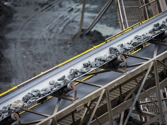 Raw materials from a mine being processed on a conveyor belt