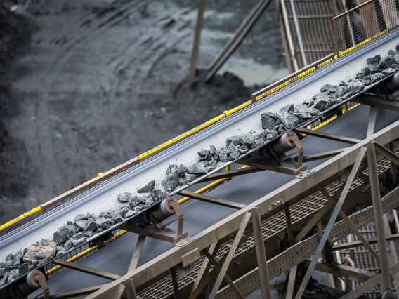 Raw materials from a mine being processed on a conveyor belt
