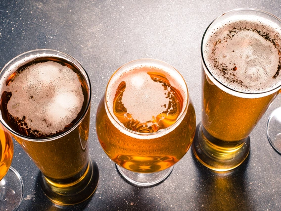 A row of differing beer glasses and beer types