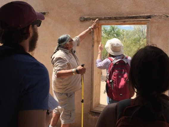 People examining a historical structure