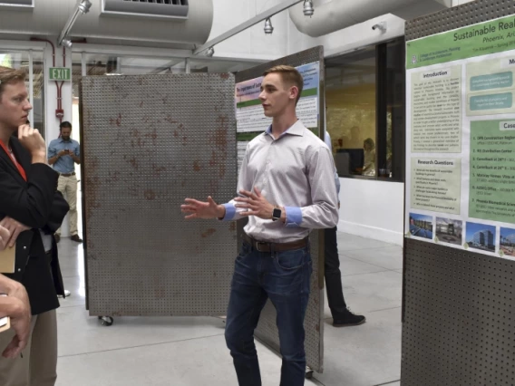 A man giving a poster presentation