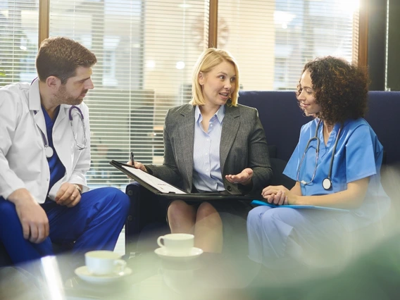Two doctors and a professional having a meeting together