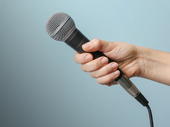 hand holding out microphone for an interview