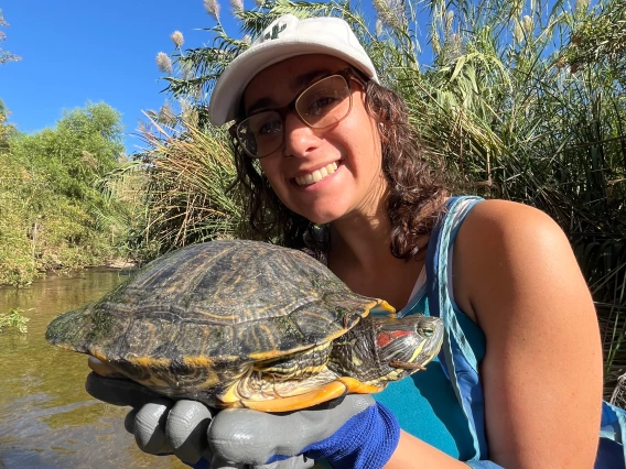 Stephanie Winick holds a turtle outside