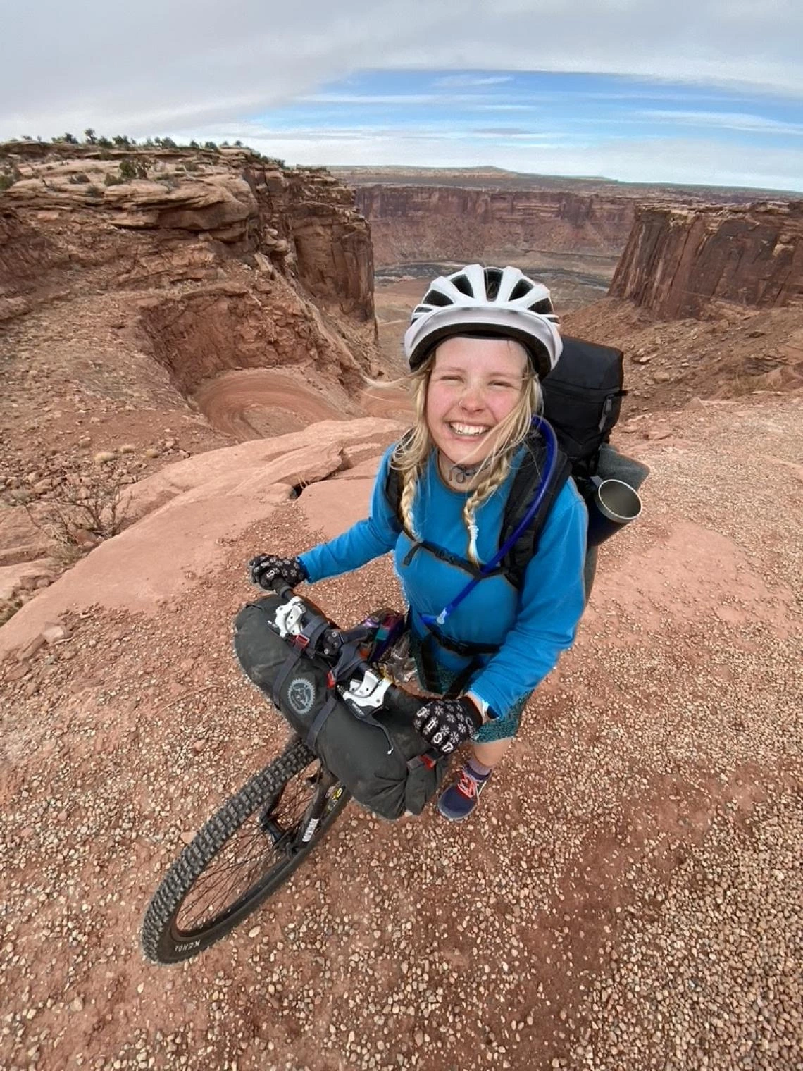 Franny Slater riding a bike in the desert