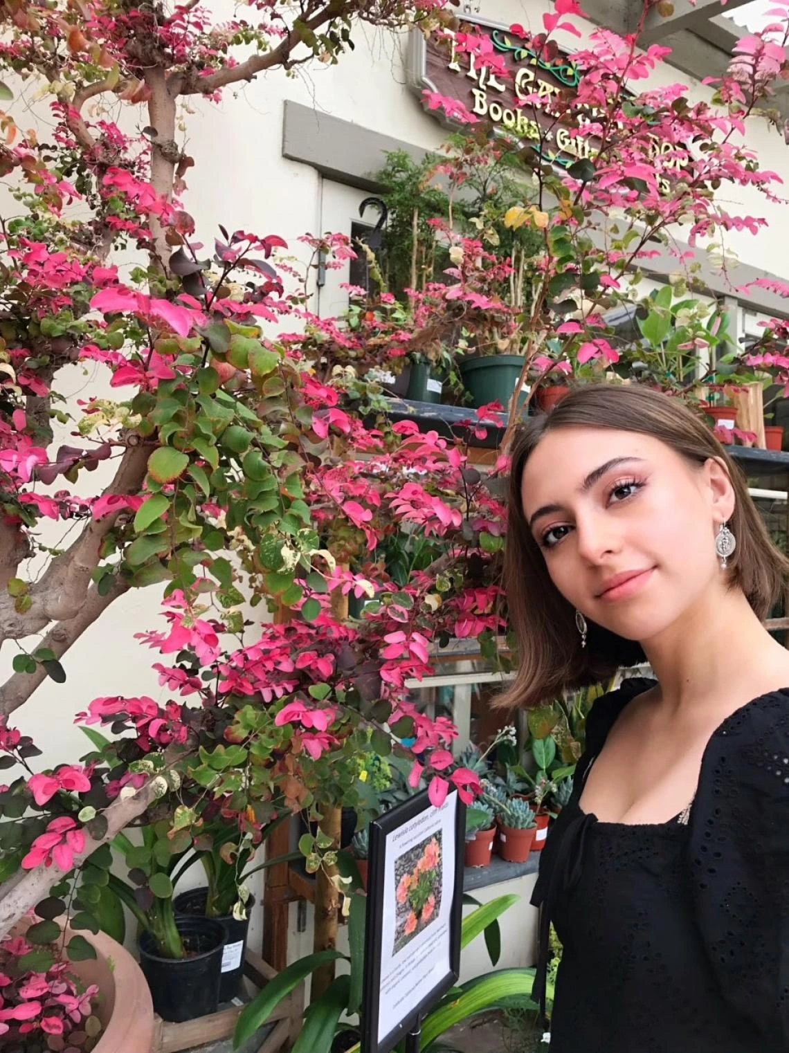 Sam Wetherell next to a floral arrangement