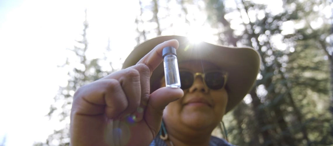 woman holding vile of water