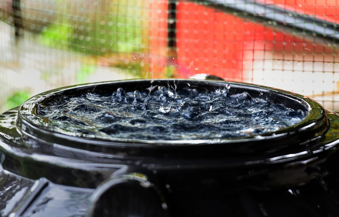 Water falling into a plastic bin.