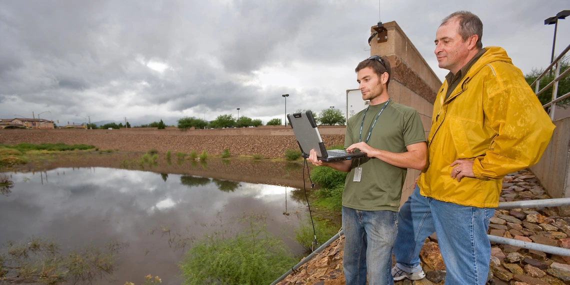 David Goodrich taking a water sample