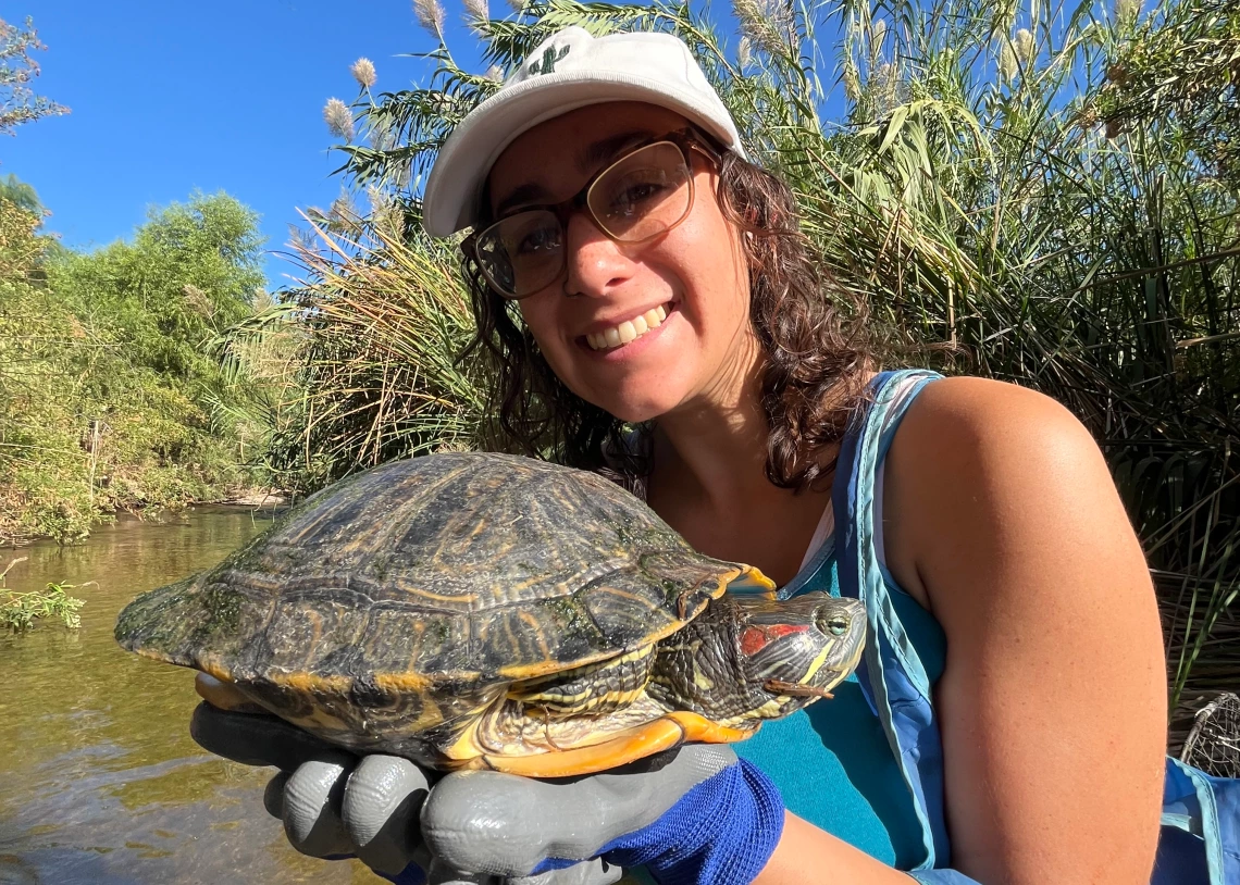 Stephanie Winick holds a turtle outside