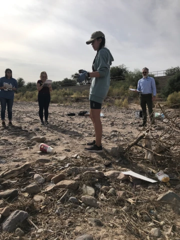 Earth Grant student Jamie Irby describing waste items along a transect.