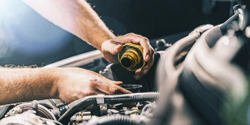 A mechanic's hands working on a car