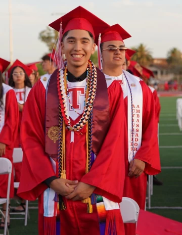 Ruben Aguirre in red graduation cap and gown.